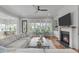 Bright living room featuring a fireplace, hardwood floors, and ample natural light at 120 Hazel Alder Ct, Holly Springs, NC 27540