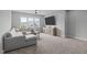 Inviting living area with comfortable seating, media center, and neutral carpet at 120 Hazel Alder Ct, Holly Springs, NC 27540