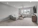 Bright living room features a comfortable sectional sofa, ceiling fan, and large windows at 120 Hazel Alder Ct, Holly Springs, NC 27540