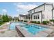Spacious backyard featuring a pool, spa, and screened porch, perfect for relaxation at 120 Hazel Alder Ct, Holly Springs, NC 27540