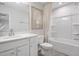 Bright bathroom features a framed mirror, white cabinets, and a shower with a patterned curtain at 1213 Everton Ave, Durham, NC 27703