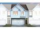 Charming townhome exterior showcasing a two-car garage, modern design and inviting curb appeal at 1213 Everton Ave, Durham, NC 27703