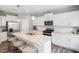 Bright kitchen with white cabinets, stainless steel appliances, granite countertops, and large center island at 1213 Everton Ave, Durham, NC 27703