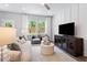 Comfortable living room with bright windows, contemporary furniture, stylish decor and an open concept design at 1213 Everton Ave, Durham, NC 27703