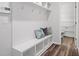Organized mudroom with bench seating, open shelving, and hooks for storage at 1213 Everton Ave, Durham, NC 27703