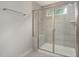 Modern bathroom features a glass shower enclosure with a built-in seat and a small window for natural light at 1215 Everton Ave, Durham, NC 27703
