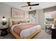 Cozy bedroom featuring a bed with a decorative headboard, ambient lighting, and large windows for natural light at 1215 Everton Ave, Durham, NC 27703