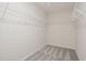 Walk-in closet with carpeted floor and white wire shelving offers ample storage space at 1215 Everton Ave, Durham, NC 27703