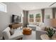 Well-lit living room featuring a cozy sectional sofa, stylish coffee table, and an entertainment center at 1215 Everton Ave, Durham, NC 27703