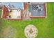 A beautifully landscaped backyard includes a deck, stone fire pit, and inviting outdoor space at 1217 Heritage Greens Dr, Wake Forest, NC 27587