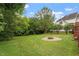 Backyard featuring a circle fire pit and a well-maintained lawn at 1217 Heritage Greens Dr, Wake Forest, NC 27587
