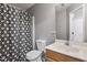 Neutral bathroom featuring a patterned shower curtain, wood vanity, and a large mirror at 1217 Heritage Greens Dr, Wake Forest, NC 27587