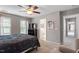 Bright bedroom offering carpeted floors, neutral paint, ceiling fan and plenty of natural light at 1217 Heritage Greens Dr, Wake Forest, NC 27587