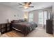 Cozy bedroom featuring a ceiling fan, neutral walls, and natural light from multiple windows at 1217 Heritage Greens Dr, Wake Forest, NC 27587