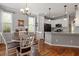 Charming dining area features hardwood floors, modern lighting, and flows into the kitchen at 1217 Heritage Greens Dr, Wake Forest, NC 27587