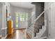 Bright foyer with hardwood floors, staircase, and decorative glass front door creates an inviting entryway at 1217 Heritage Greens Dr, Wake Forest, NC 27587