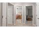 Hallway view with neutral paint and carpet leading to a bedroom and another room at 1217 Heritage Greens Dr, Wake Forest, NC 27587
