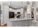 Bright kitchen with white cabinets, granite countertops, stainless steel appliances, and a kitchen island at 1217 Heritage Greens Dr, Wake Forest, NC 27587