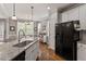 Bright eat-in kitchen featuring a center island, stainless steel appliances and hardwood floors at 1217 Heritage Greens Dr, Wake Forest, NC 27587