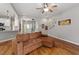 Cozy living room with hardwood floors and ceiling fan flows into the dining area and kitchen at 1217 Heritage Greens Dr, Wake Forest, NC 27587