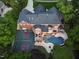 Stunning aerial view of backyard with pool, patio, basketball court, and putting green at 123 Trellingwood Dr, Morrisville, NC 27560