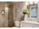 Modern bathroom showcasing a marble vanity, decorative mirror, and a glass-enclosed shower with sleek fixtures and tiling at 123 Trellingwood Dr, Morrisville, NC 27560
