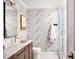 Bathroom features a modern vanity, patterned wallpaper, and sleek glass shower enclosure at 123 Trellingwood Dr, Morrisville, NC 27560