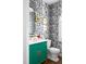 Charming powder room with designer wallpaper, a green vanity, and gold fixtures at 123 Trellingwood Dr, Morrisville, NC 27560
