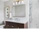 Bathroom features a white marble shower, sleek vanity with modern lighting and a framed mirror above the vessel sink at 123 Trellingwood Dr, Morrisville, NC 27560