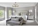 A relaxing main bedroom with a large bed, side tables, and lots of natural light at 123 Trellingwood Dr, Morrisville, NC 27560