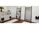 Exercise room featuring a mirrored wall, workout equipment, cubbies, and fitness mats on a hardwood floor at 123 Trellingwood Dr, Morrisville, NC 27560