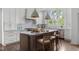 Spacious kitchen featuring a large center island, modern appliances and white cabinetry at 123 Trellingwood Dr, Morrisville, NC 27560
