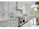 Well-equipped kitchen with stainless steel range, white marble counters, and custom cabinetry at 123 Trellingwood Dr, Morrisville, NC 27560