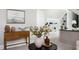 Stylish living area with a wooden console table, decorative vase, and view into the adjacent room with built-in shelving at 123 Trellingwood Dr, Morrisville, NC 27560