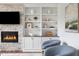 Living room showcasing stone fireplace, built-in shelving, and modern decor at 123 Trellingwood Dr, Morrisville, NC 27560