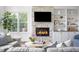 Bright living room with stone fireplace and built-in bookshelves at 123 Trellingwood Dr, Morrisville, NC 27560