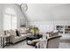 Bright and airy living room featuring built-in bookshelves and cabinets, comfortable seating, and natural light at 123 Trellingwood Dr, Morrisville, NC 27560