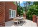 Outdoor dining area on the deck features wood-look flooring, a wooden table, and wicker chairs with comfortable cushions at 123 Trellingwood Dr, Morrisville, NC 27560