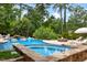 Resort-style pool with a spa, fire pit, and lounge chairs, creating an ideal backyard oasis for entertainment at 123 Trellingwood Dr, Morrisville, NC 27560