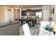 Open concept kitchen featuring an island, stainless steel appliances, dark cabinetry, and plank flooring at 1234 Sirius Drive Lot 31 Dr, Sanford, NC 27330