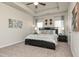 The main bedroom features a tray ceiling, carpeted floors, and a decorative headboard with sconces at 1234 Sirius Drive Lot 31 Dr, Sanford, NC 27330