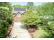 Aerial view of brick home with a two-car garage, solar panels and landscaped yard at 126 Solterra Way, Durham, NC 27705