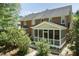 Aerial view showcasing the home's screened porch, brick exterior, and mature trees at 126 Solterra Way, Durham, NC 27705
