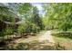 Beautifully landscaped backyard with mature trees and a charming path, perfect for outdoor enjoyment at 126 Solterra Way, Durham, NC 27705