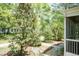 Lush backyard showcasing mature trees and partial view of screened porch addition at 126 Solterra Way, Durham, NC 27705