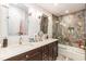 Well-lit bathroom features a double sink vanity, glass enclosed shower, and stylish fixtures at 126 Solterra Way, Durham, NC 27705
