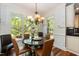 Bright breakfast nook with large windows and a stylish chandelier at 126 Solterra Way, Durham, NC 27705