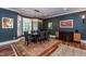 Stylish dining room features hardwood floors, a large buffet, and a modern chandelier at 126 Solterra Way, Durham, NC 27705