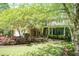 Beautiful home showcasing a large driveway leading to the two-car garage and complemented by lawn at 126 Solterra Way, Durham, NC 27705