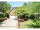 Beautiful home showcasing a large driveway leading to the two-car garage, complemented by mature landscaping at 126 Solterra Way, Durham, NC 27705